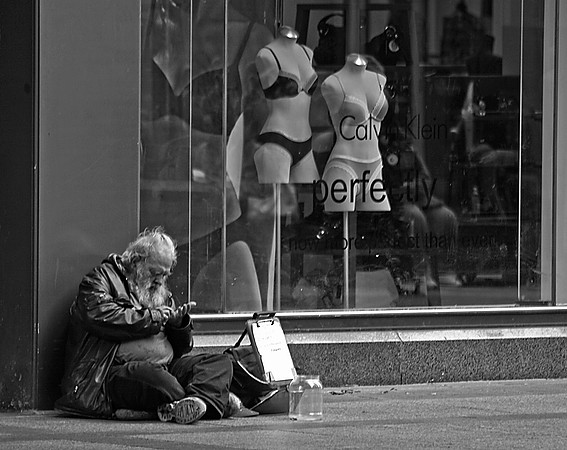 Thought ProvokingI found this scene on the Nicollet Mall interesting. A homeless man sitting in front of a window displaying high end fashionable under garments. the price some people pay for unseen f